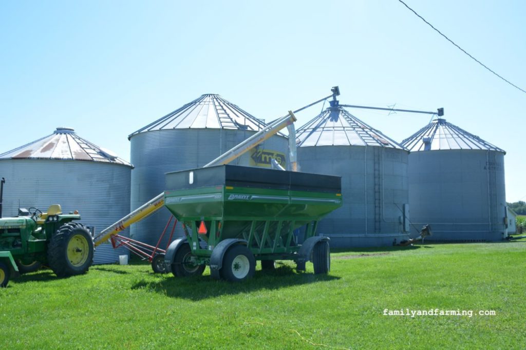 4 grain bins and tractor with wagon
