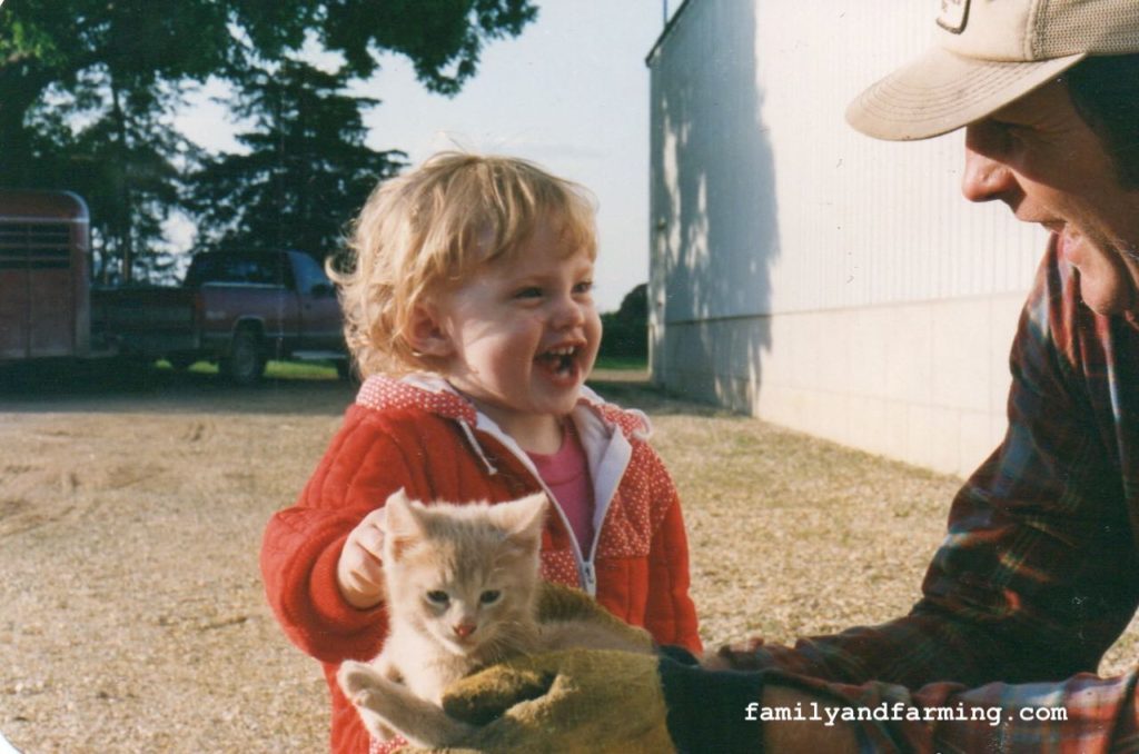 Child with farm cat